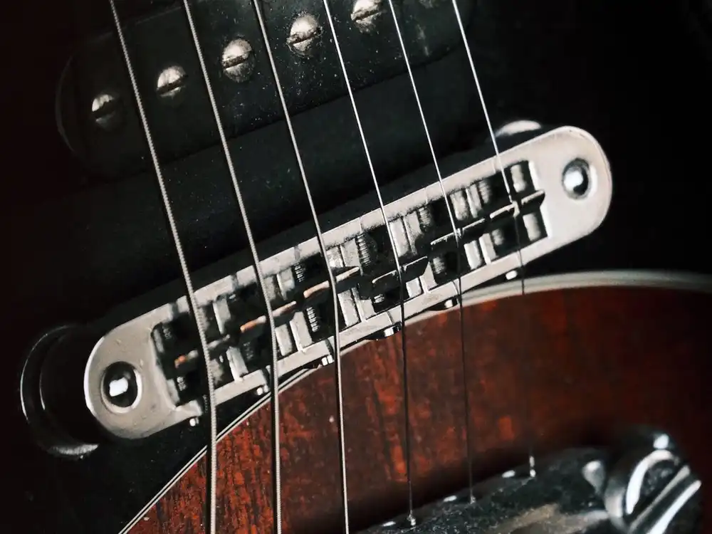 Close view of an electric guitar under stage lighting