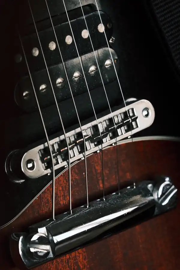 Close view of an electric guitar under stage lighting